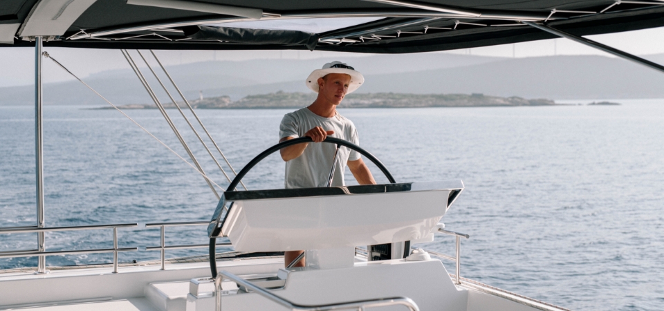 Captain sailing a catamaran on the Aegean Sea