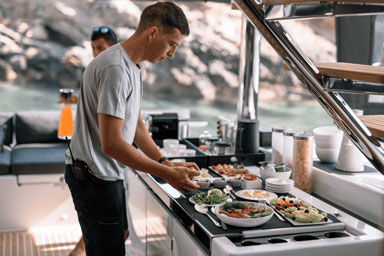 Chef preparing a meal in a luxury yacht galley