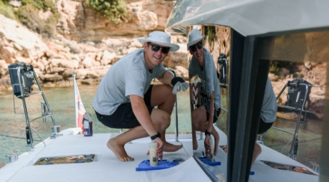 Yacht deckhand polishing and gaining experience onboard a luxury yacht