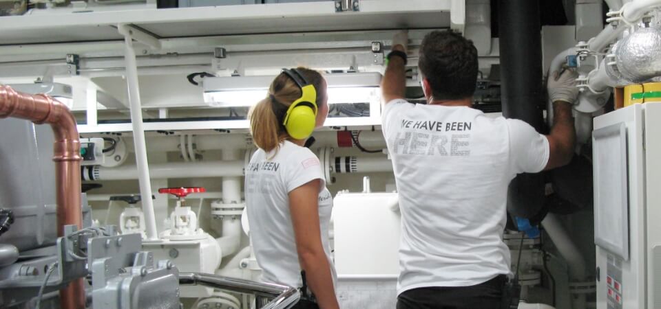 Junior engineer working in a yacht engine room