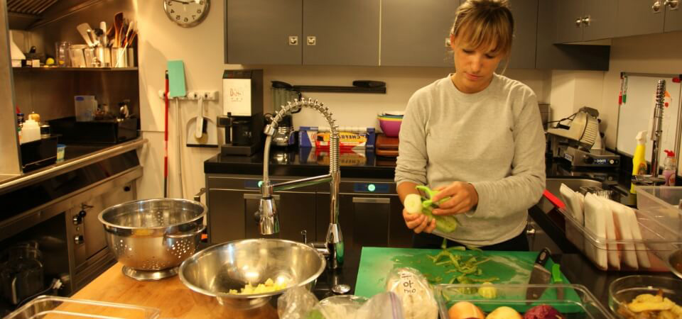 Crew working together in a yacht galley kitchen