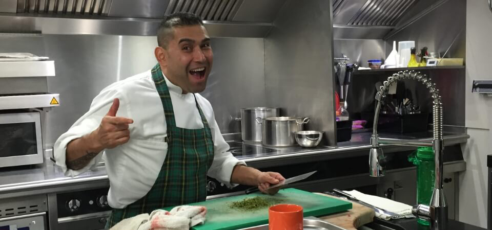 Sous Chef preparing food in a yacht galley